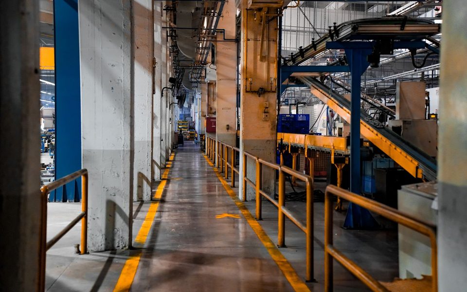 Factory floor with machinery and a yellow-marked walkway