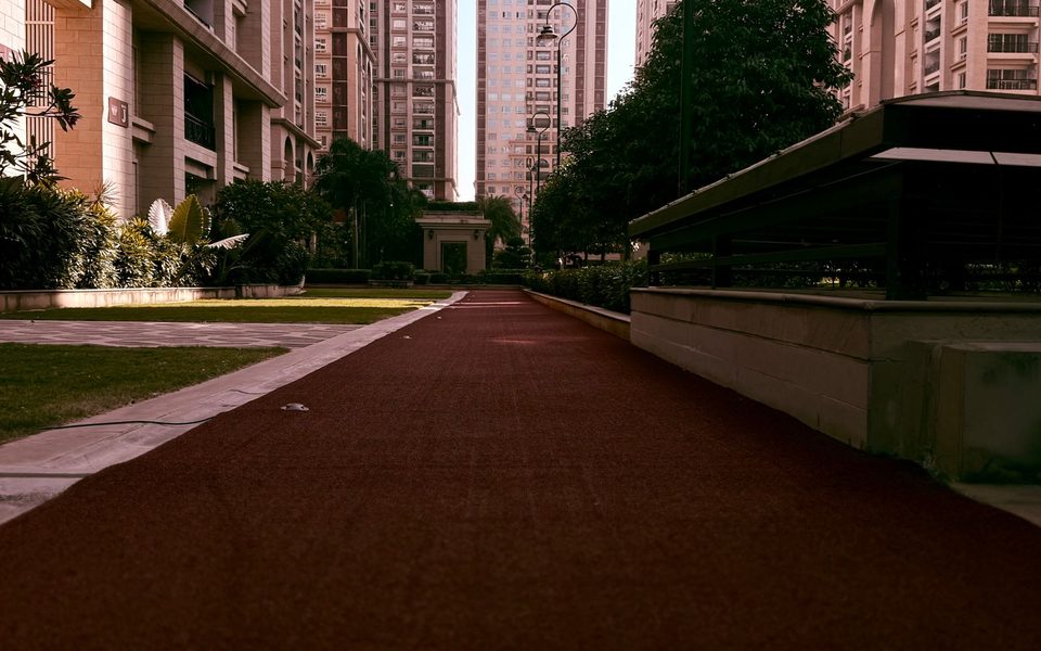 Residential society towers around a landscaped walkway